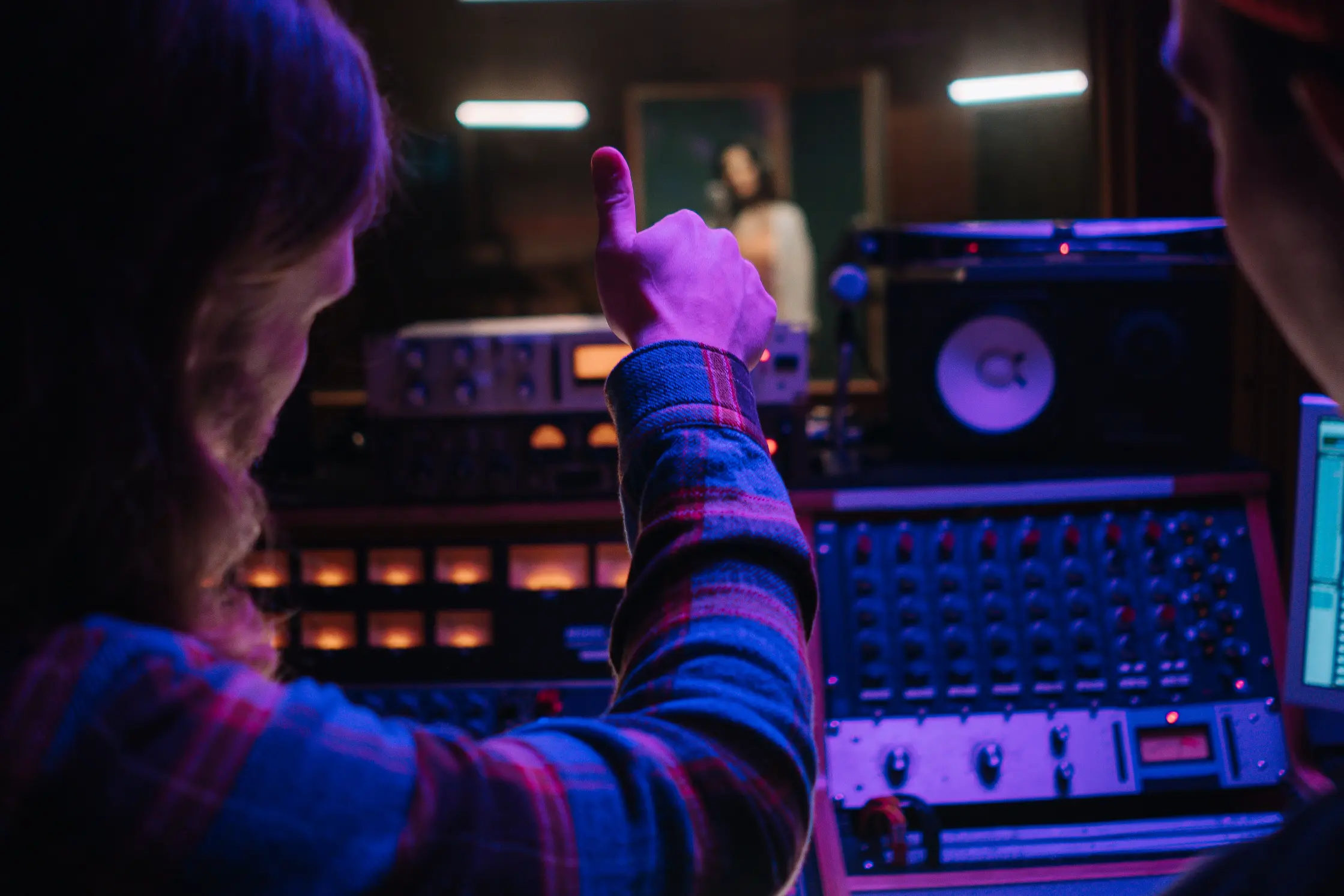 Music producer working with audio equipment during a recording session